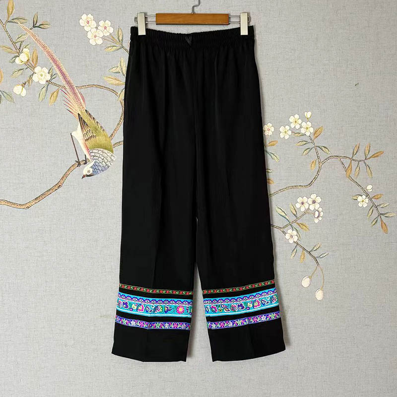 How does the integration of traditional ethnic lace techniques enhance the aesthetic value and cultural significance of modern thickened straight-leg trousers?